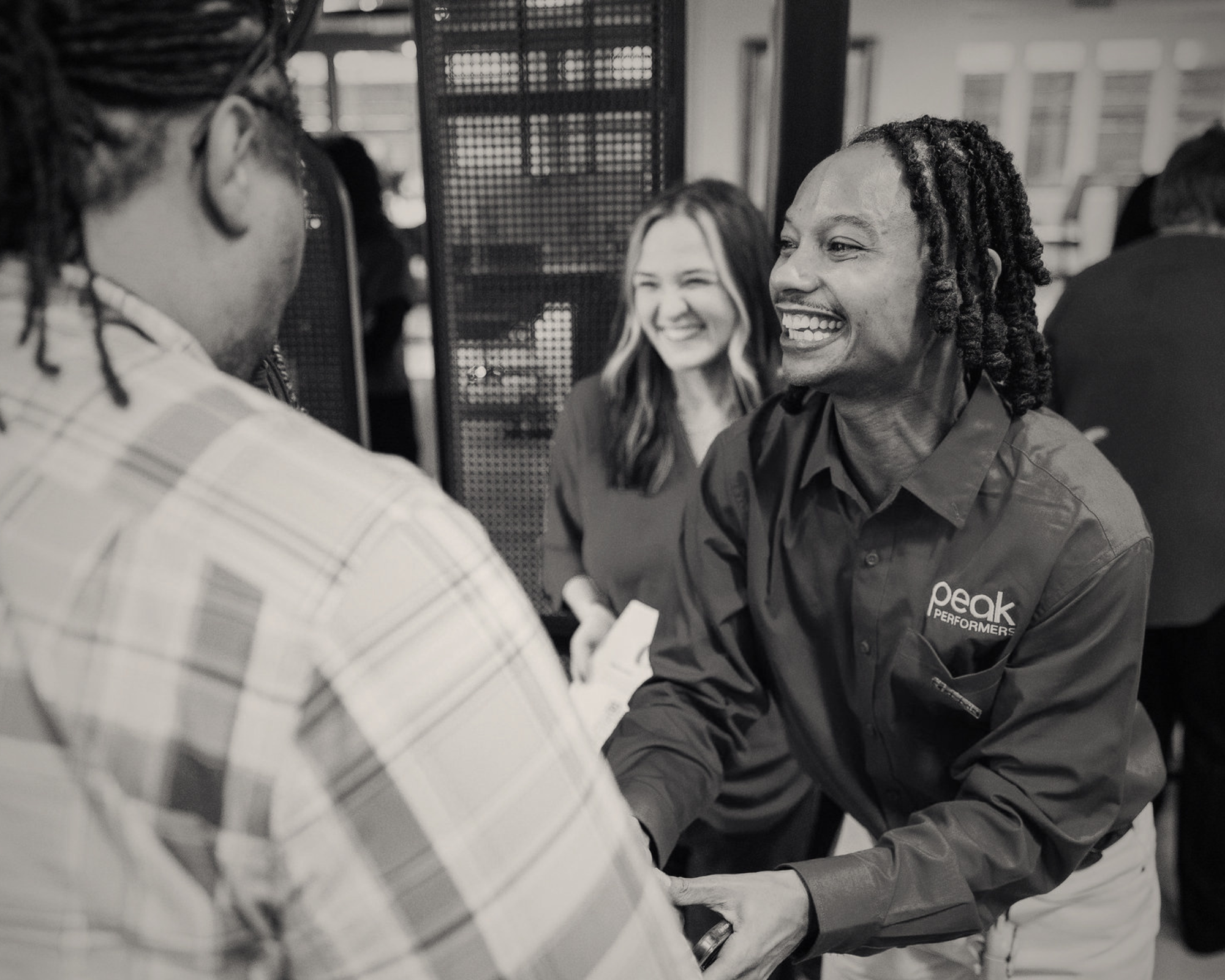 Peak employee smiles and shakes hands with a jobseeker