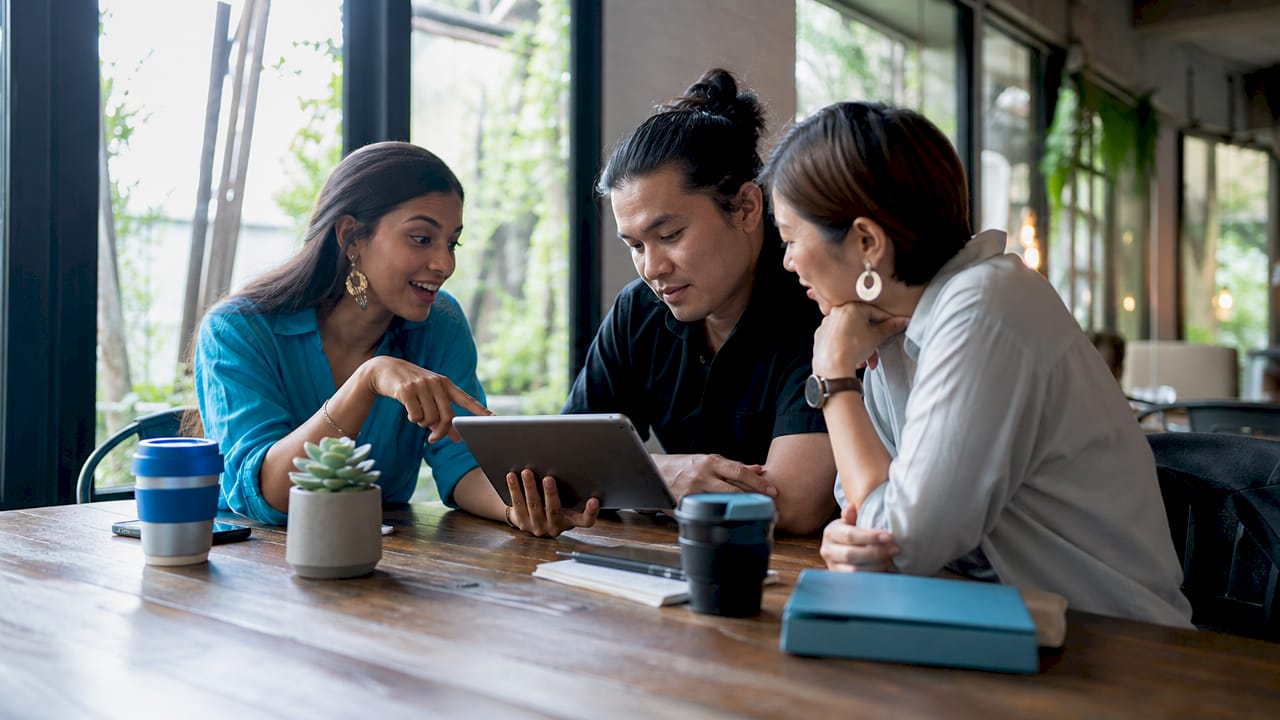 Team discussing social media tactics around a table