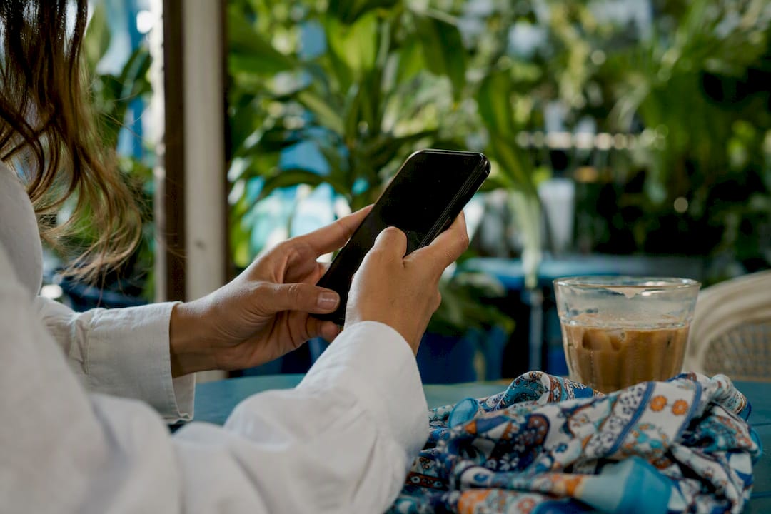 Hands poised to engage with Twitter on smartphone