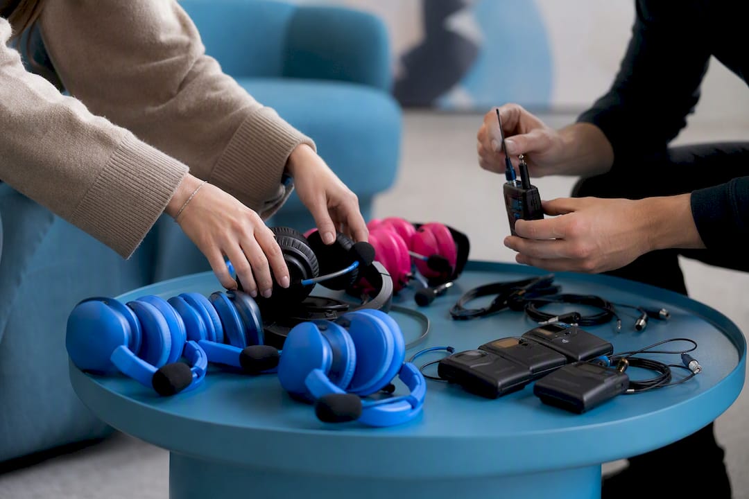 Hands setting up headset and microphone gear