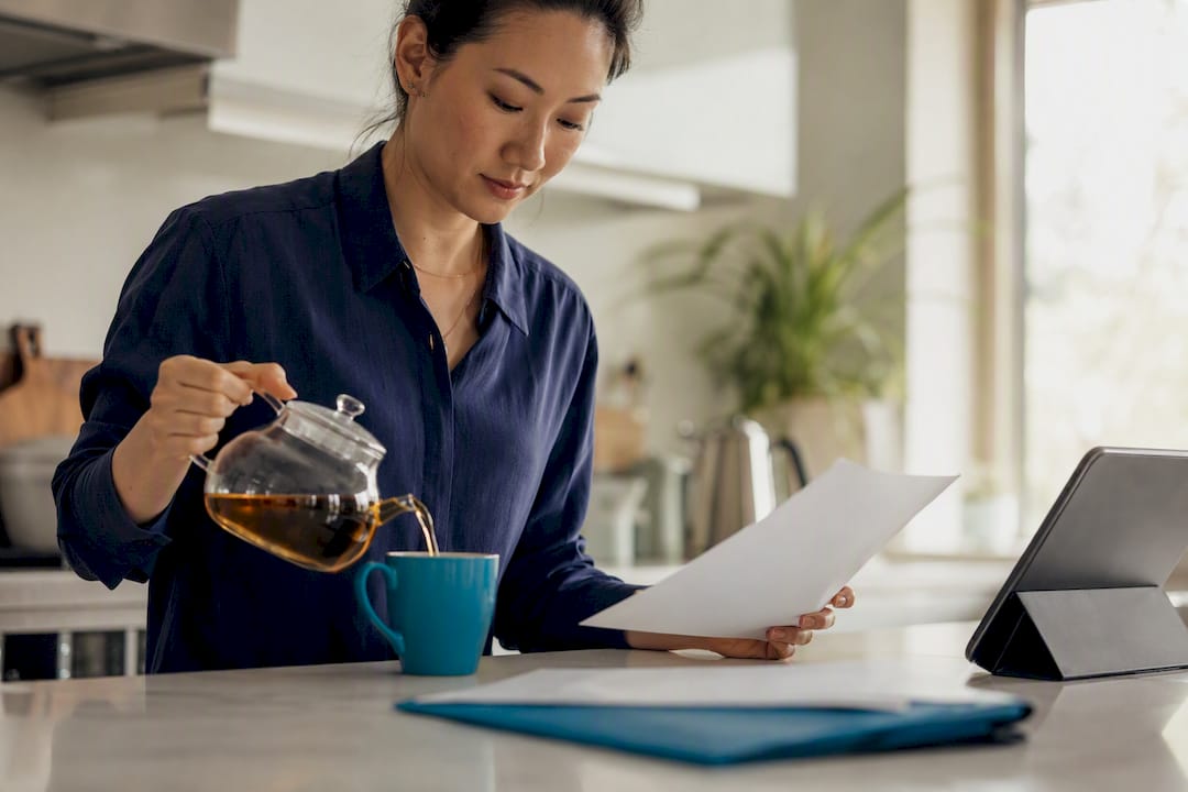 Hands pouring tea during tax self-disclosure moment
