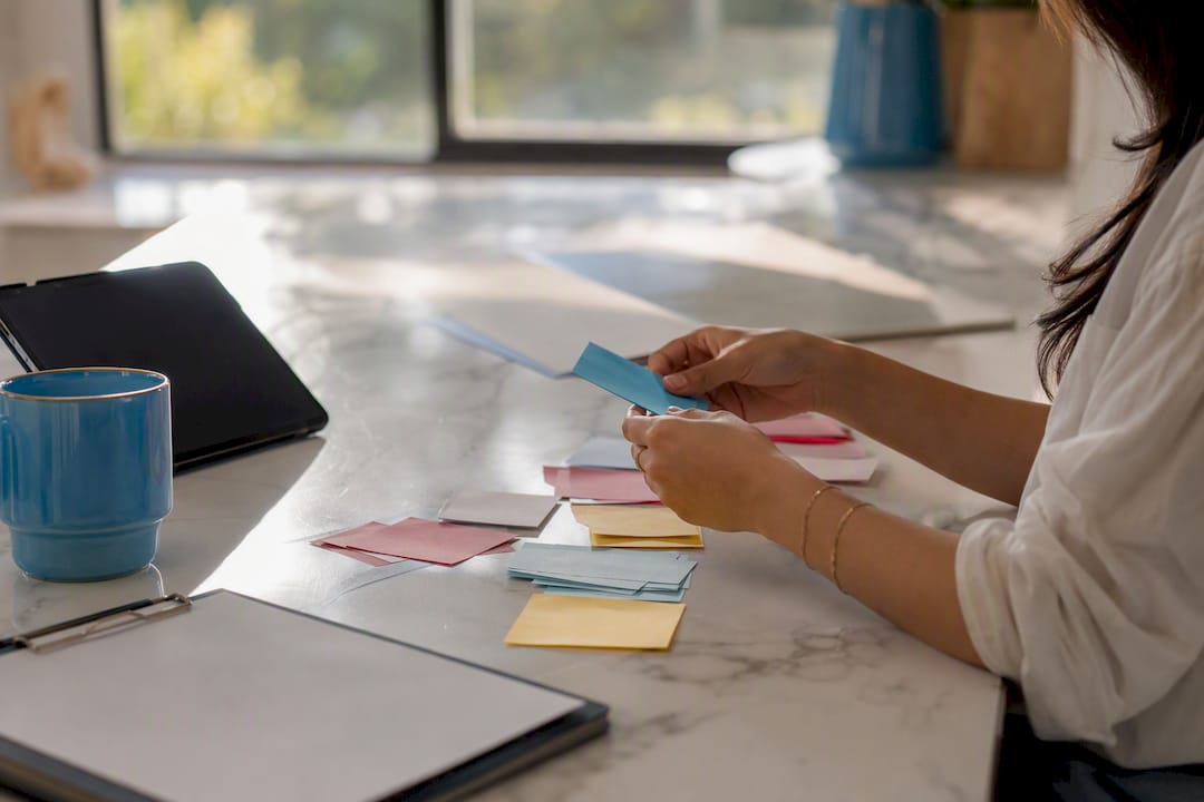 Hands organizing subscriber cards at desk