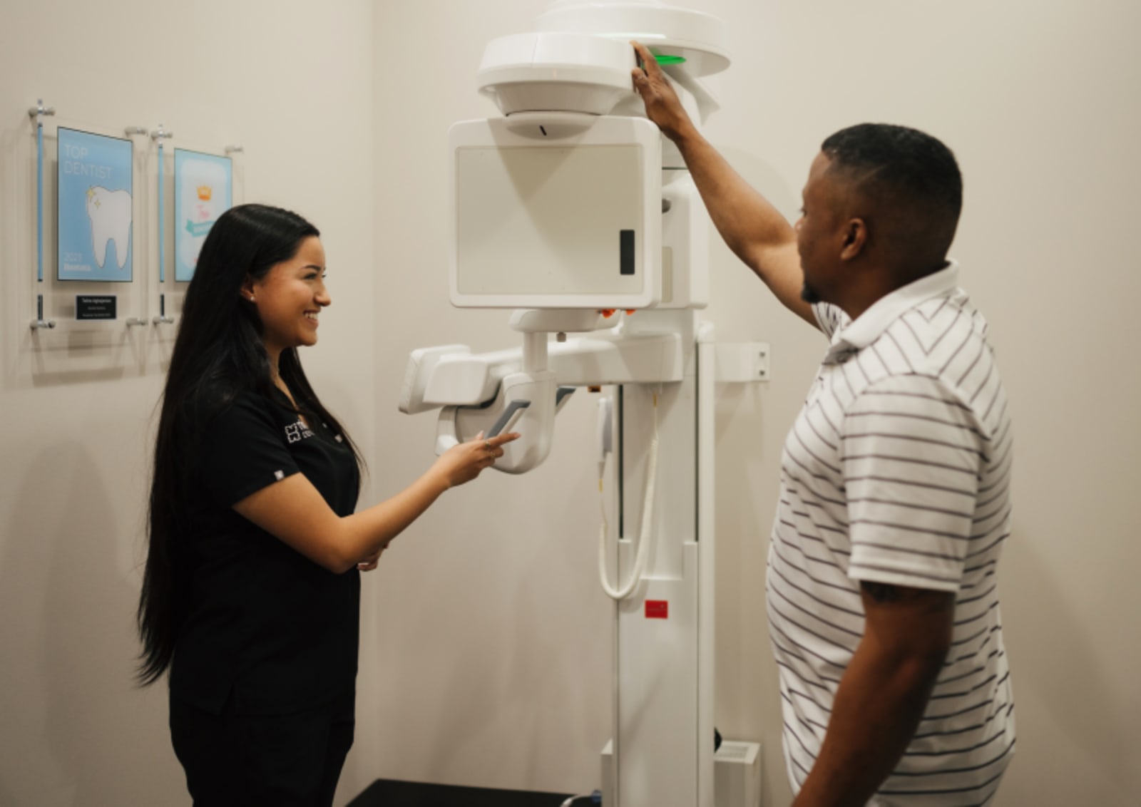 Dentist in white coat explaining treatment options to male patient in clinical examination room