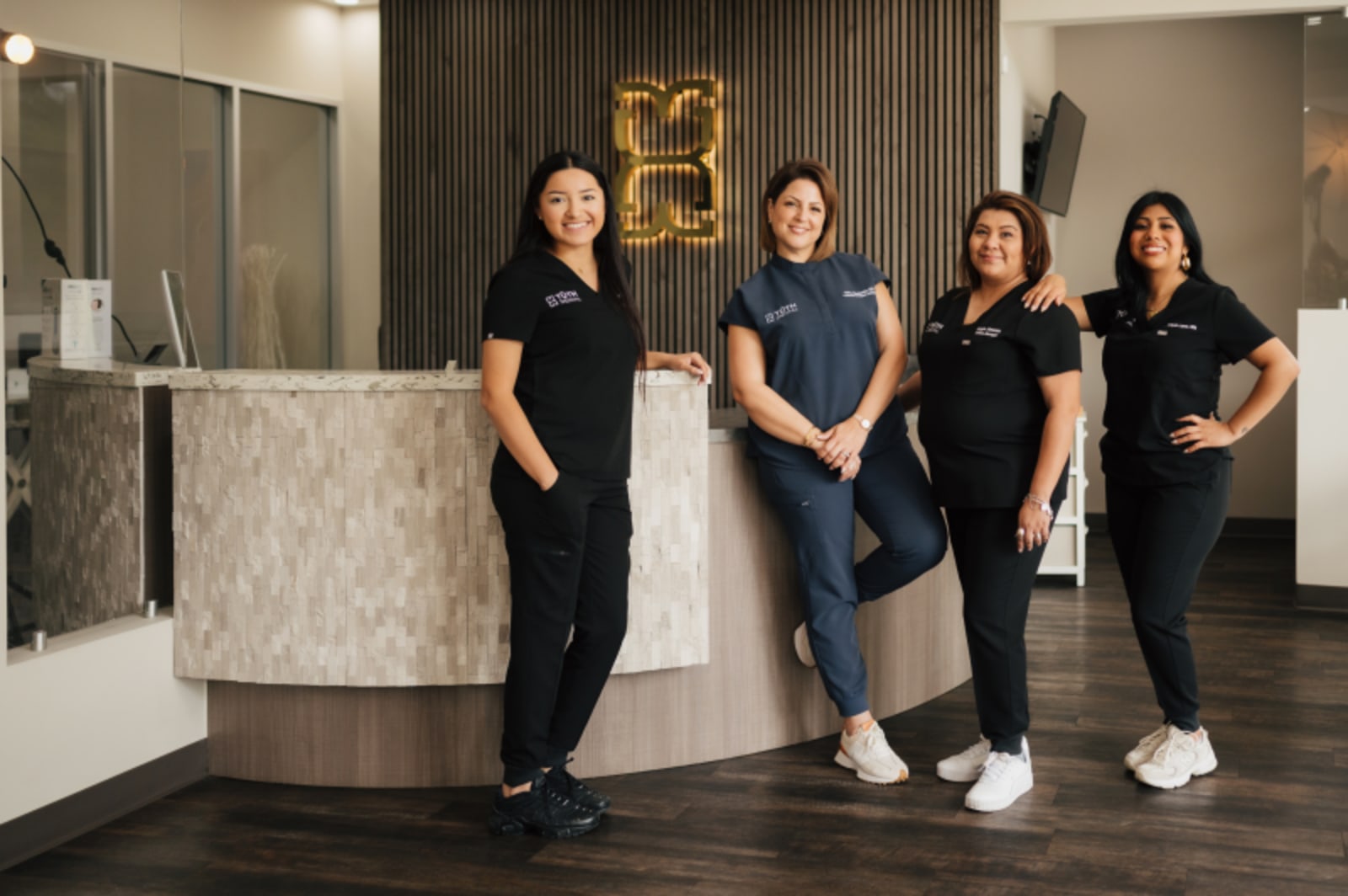 TUTH Dental team posing for a picture in the lobby in Katy, TX