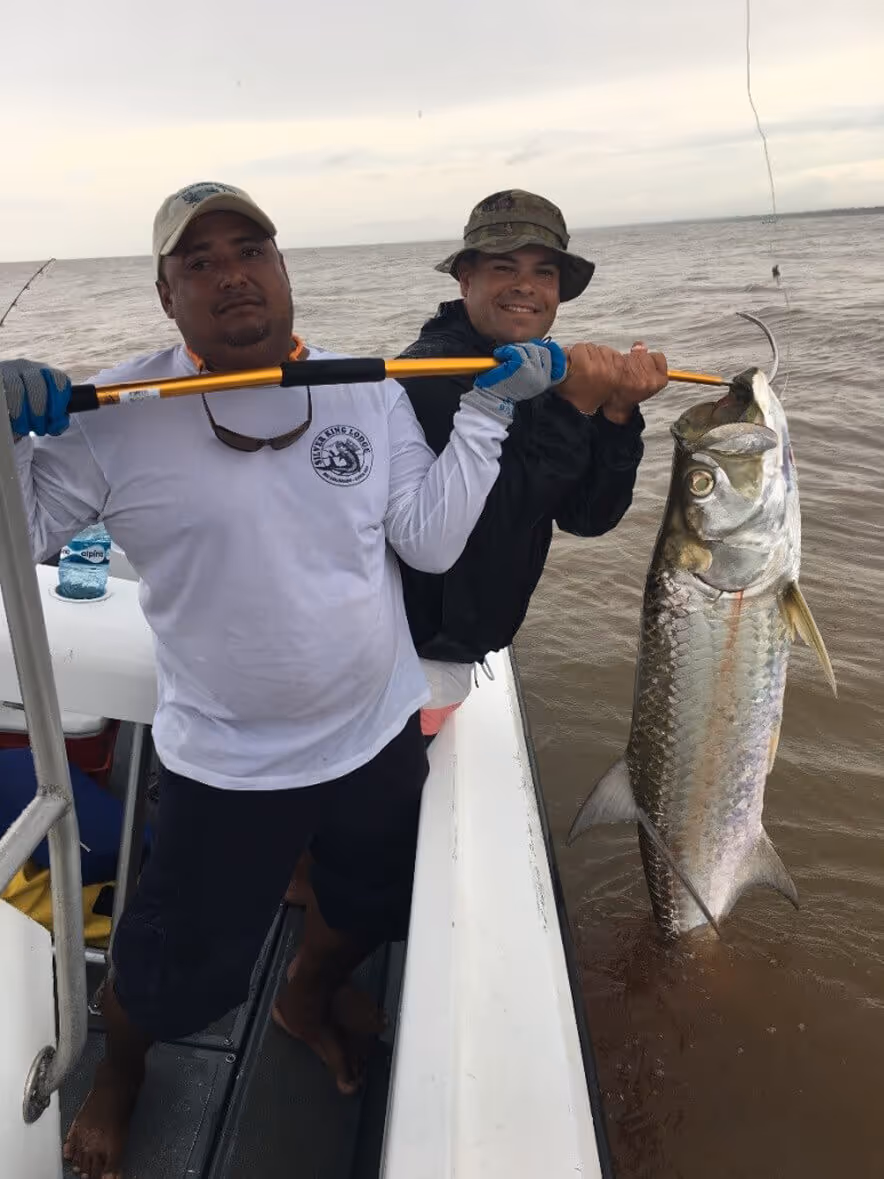 veterans showing caught fish on a boat