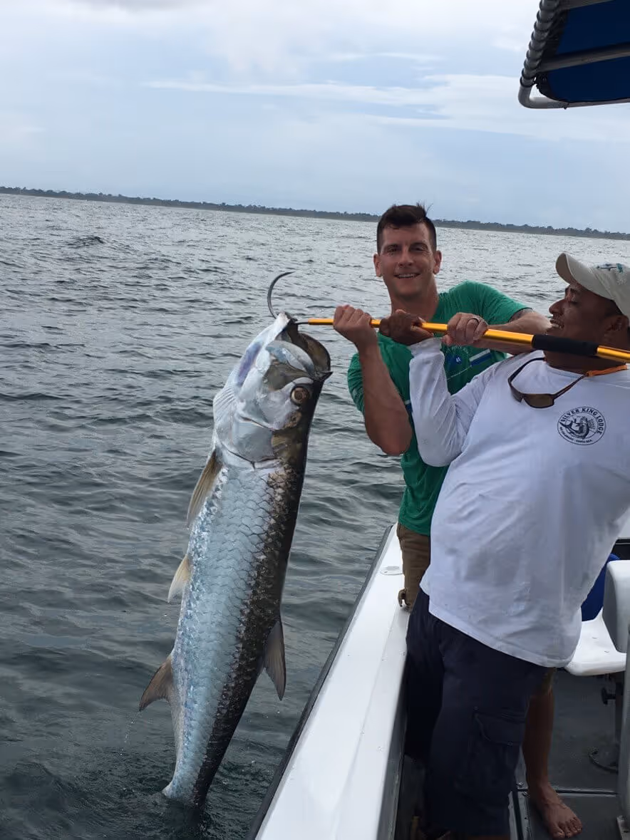 veterans showing caught fish on a boat
