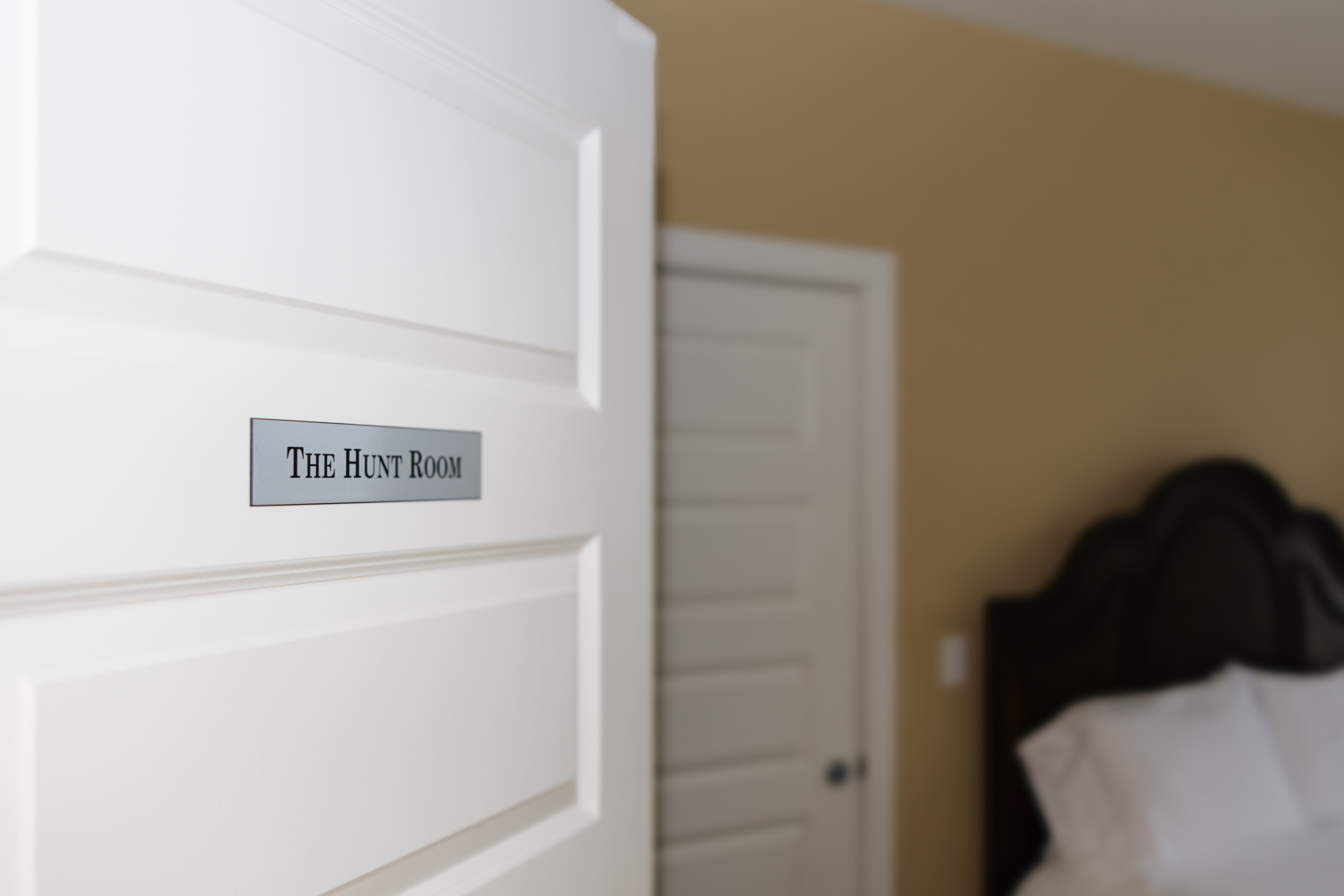 Armoire and open bathroom doorway in The Hunt Room