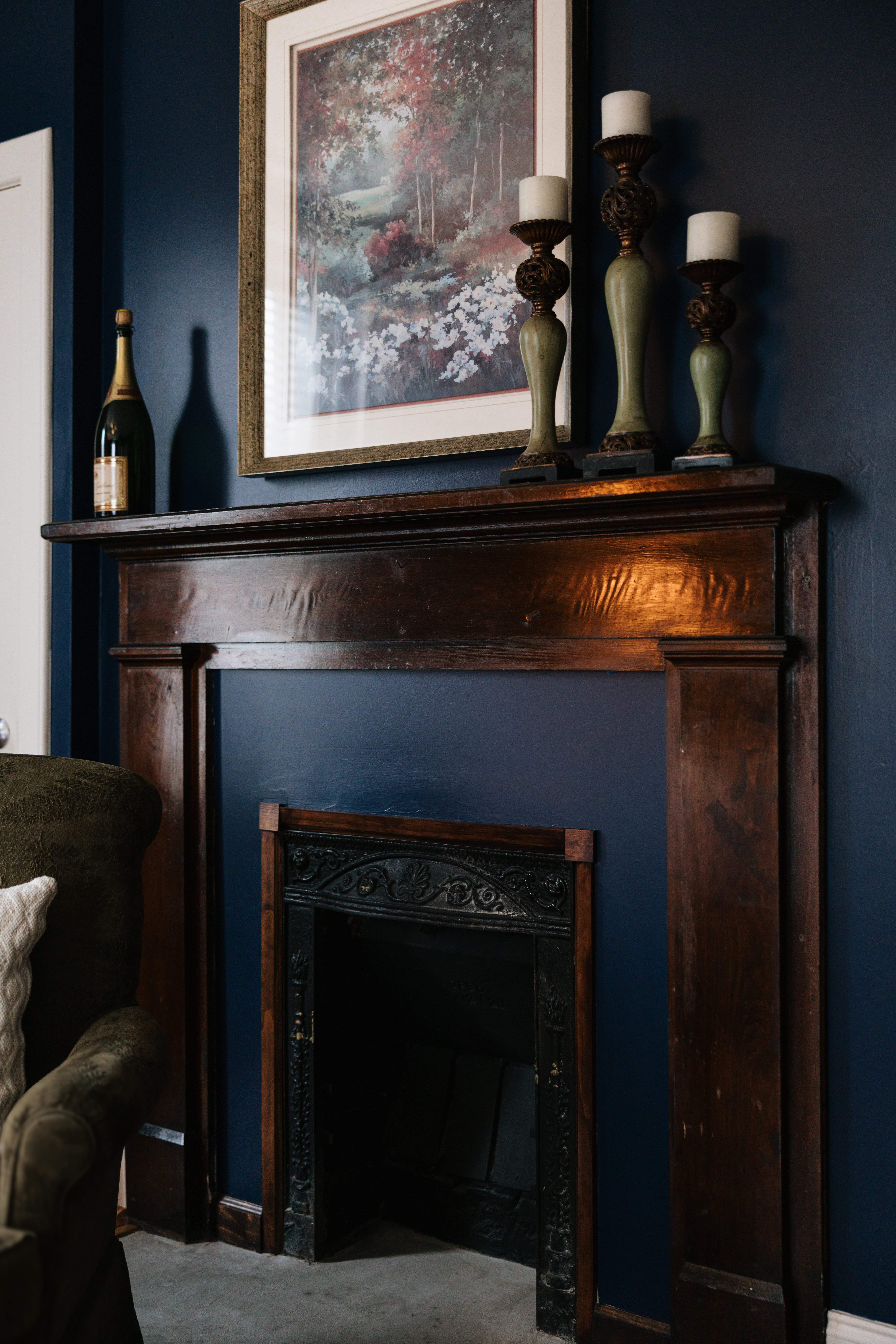 Fireplace mantel with art and candlesticks in The Georgia Room