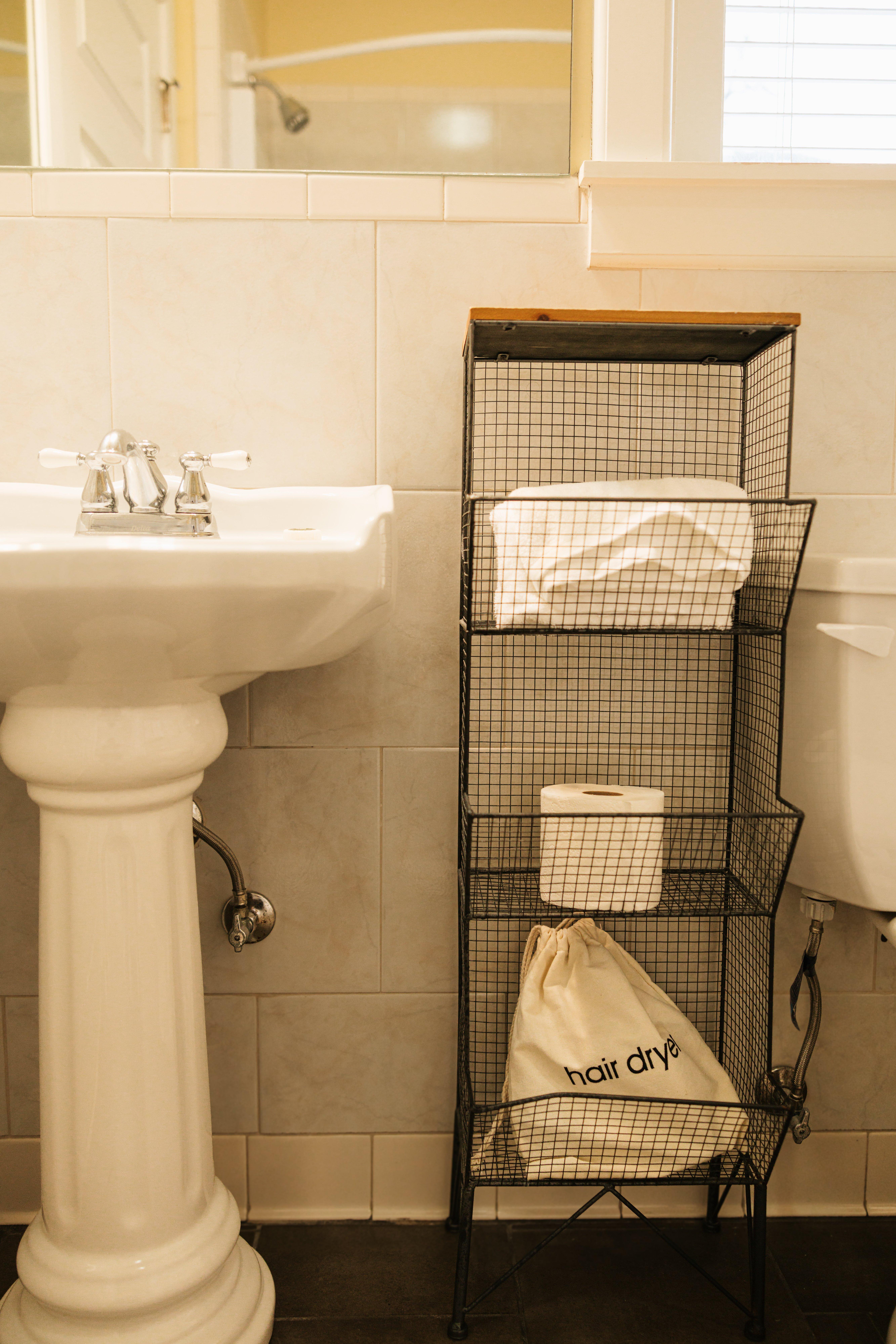Folded towels on the bathroom shelf in The Chezy Room