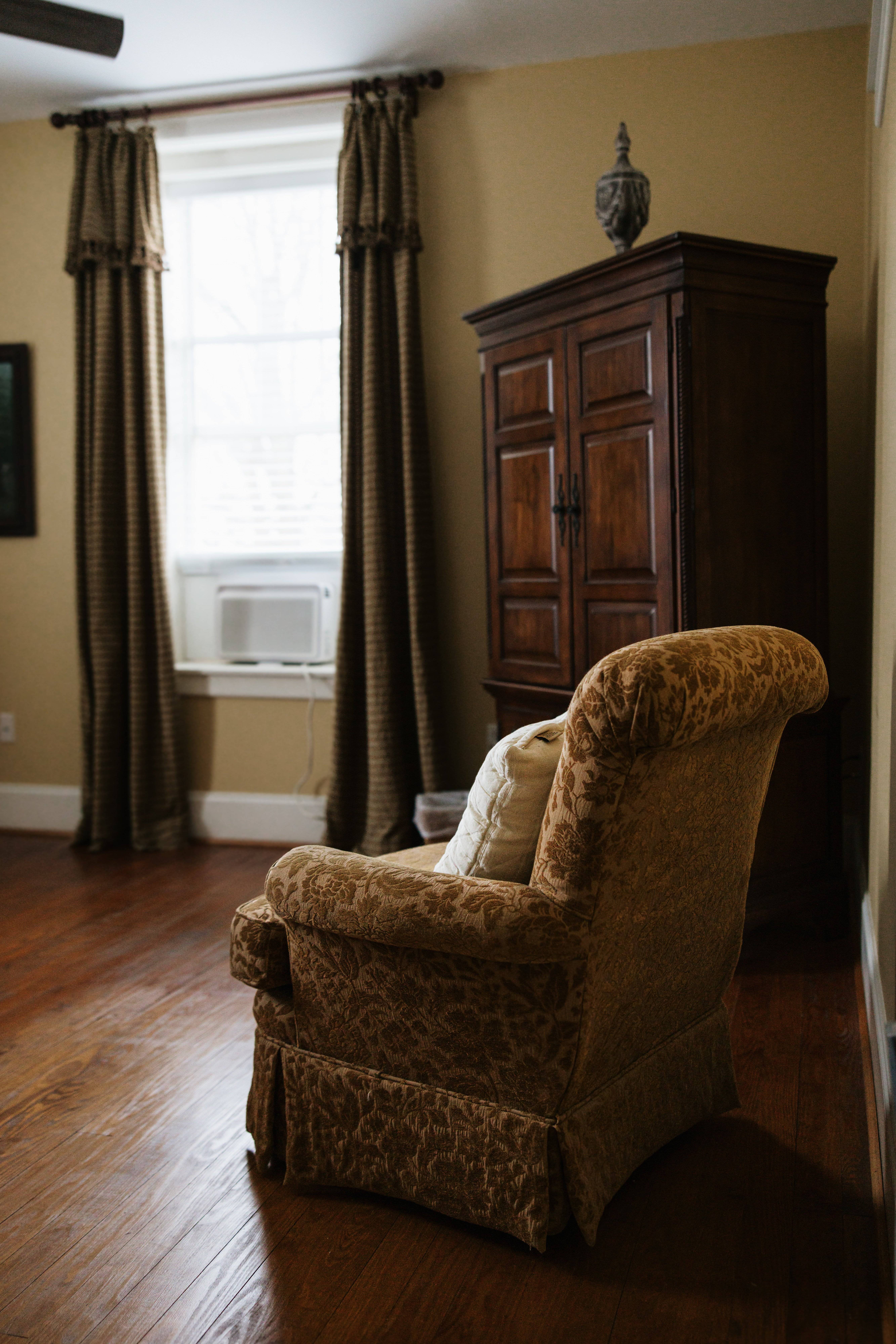 Armchair and armoire by the window in The Carlyle Room