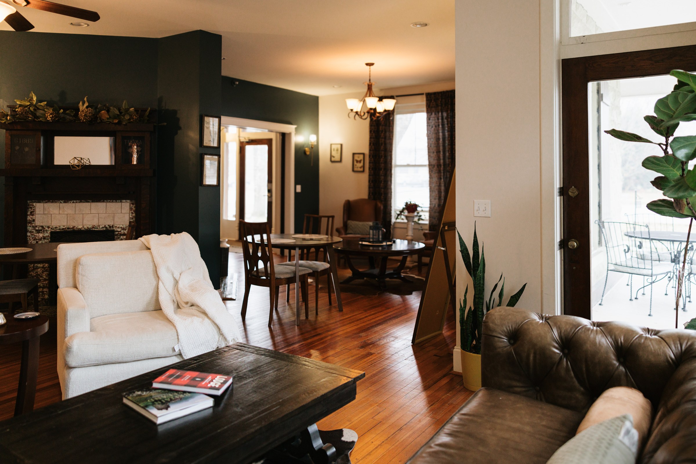 Wide view of The Grand Lux Inn's living rooms with comfortable sofas and warm natural light
