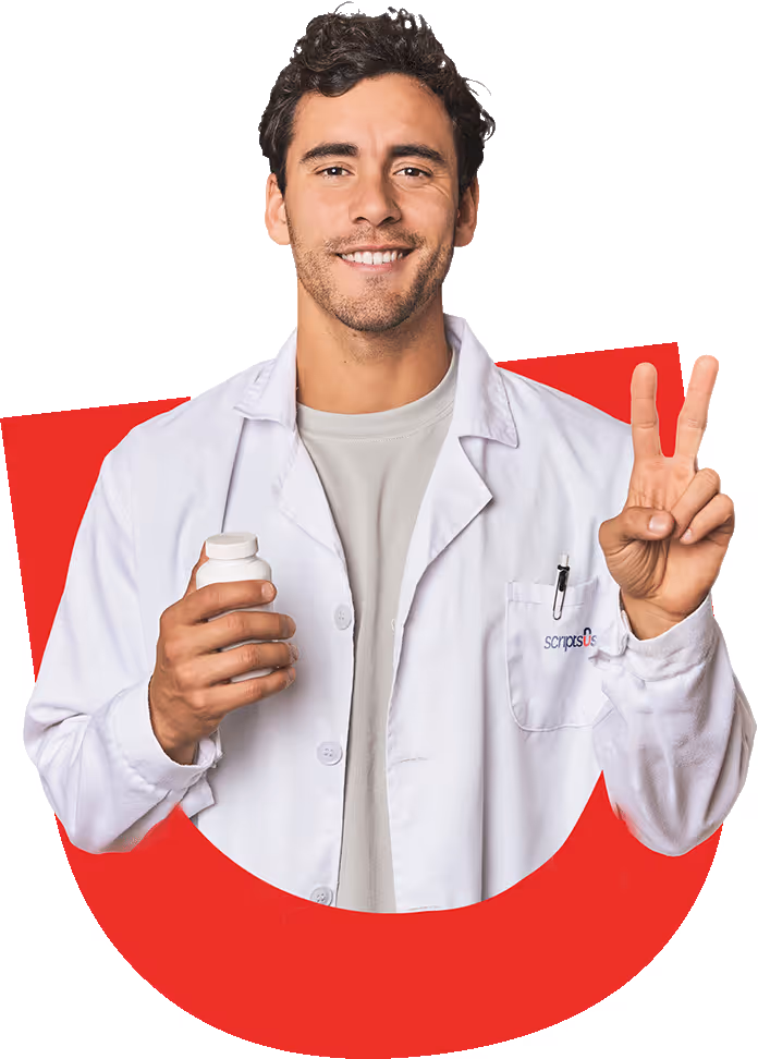 A man in Scripts USA white lab coat holding a bottle of medication