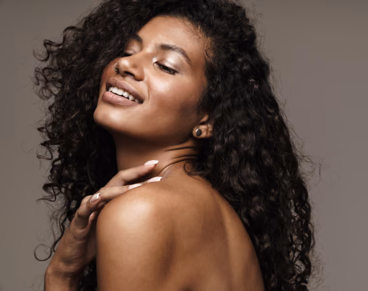 Beautiful woman looking to the side and holding her shoulder