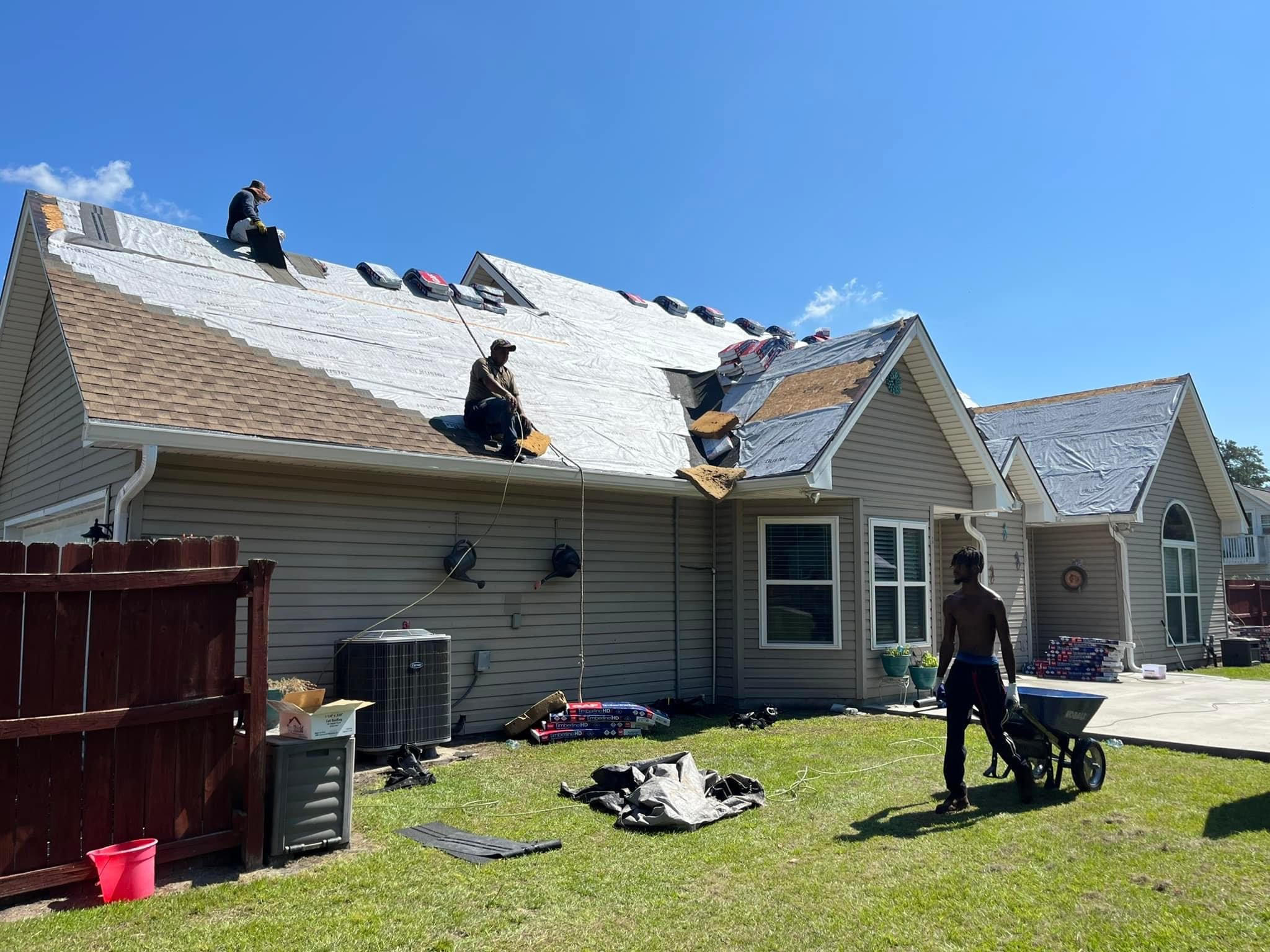 Contractors repairing a roof.