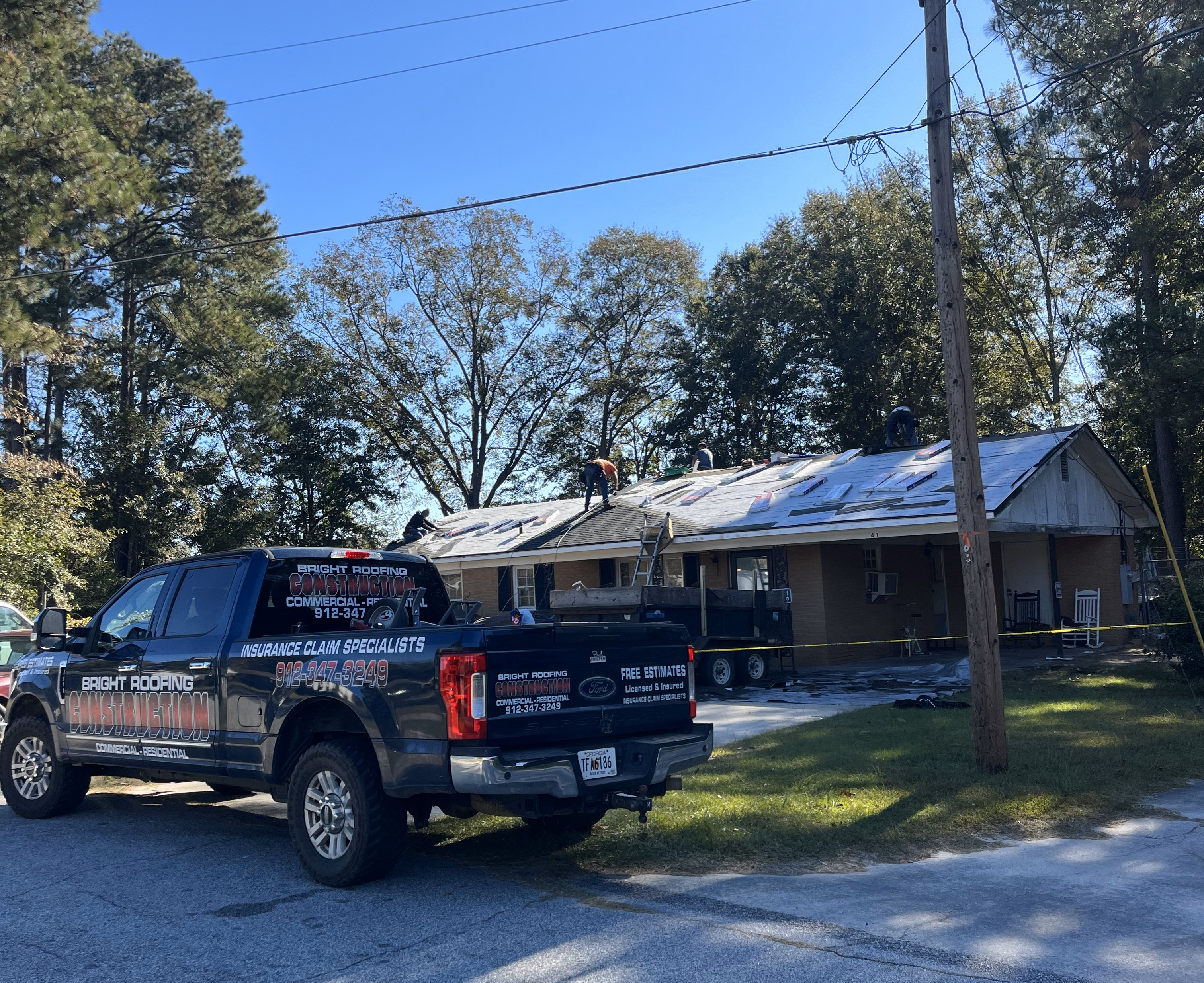 Contractors repairing a roof.