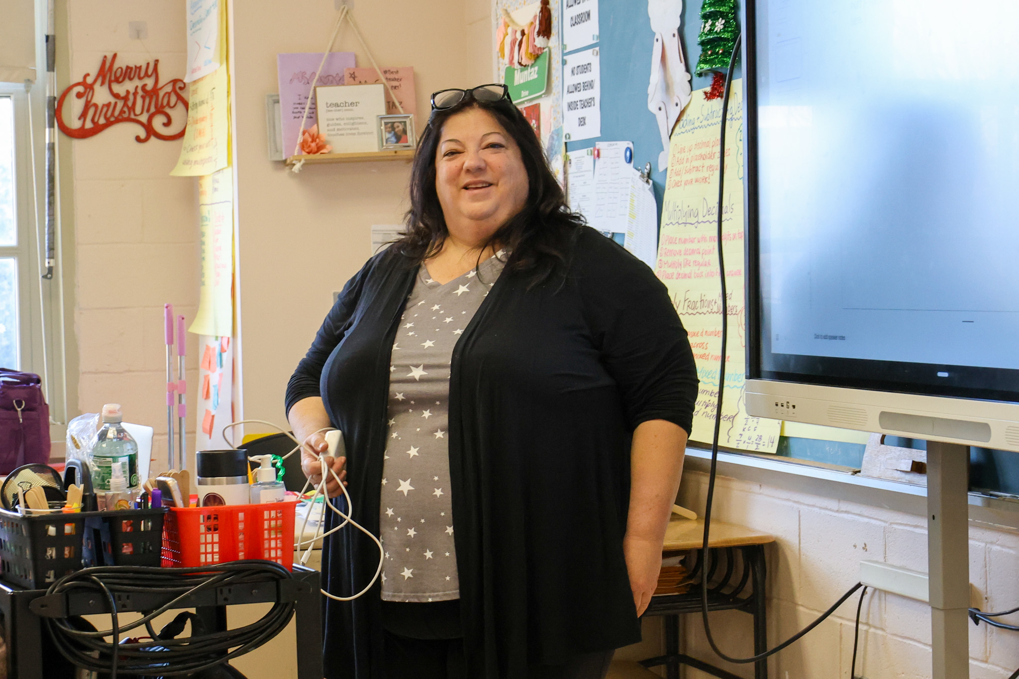 Isabell Peragine smiling in her decorated classroom