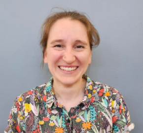 Francine Cilke smiling in a floral shirt against gray background