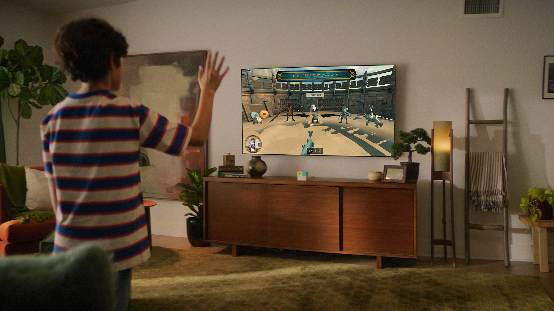 Boy raising his hand to select a dragon in Nex Playground's How to Train Your Dragon: Riders of the Skies
