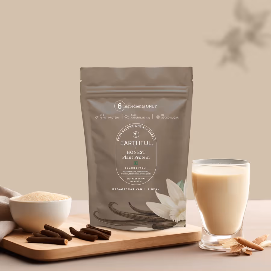 A packet of Honest Plant Protein – Madagascar Vanilla powder alongside a glass of milk and powder mixer.
