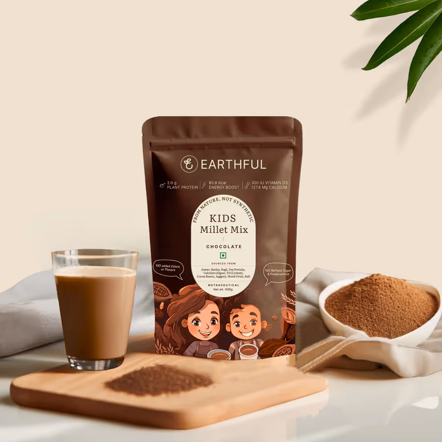 A pouch of Earthful Kids Millet Mix powder alongside a glass of mixed milk and powder.