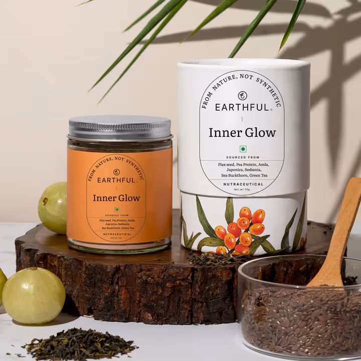 A bottle of Earthful Inner Glow Blend powder alongside its outer cover.