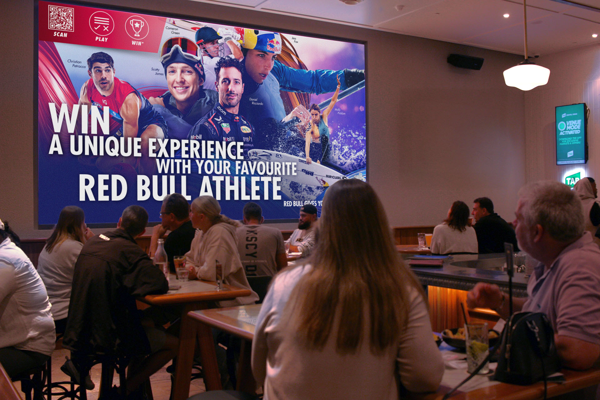 A redbull promotional screen displaying a QR code at a trivia venue