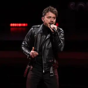 dean boeken zingend in zwarte kledij