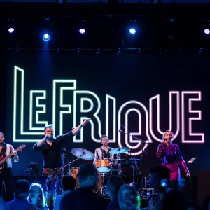 lefrique boeken op podium met logo achter hen