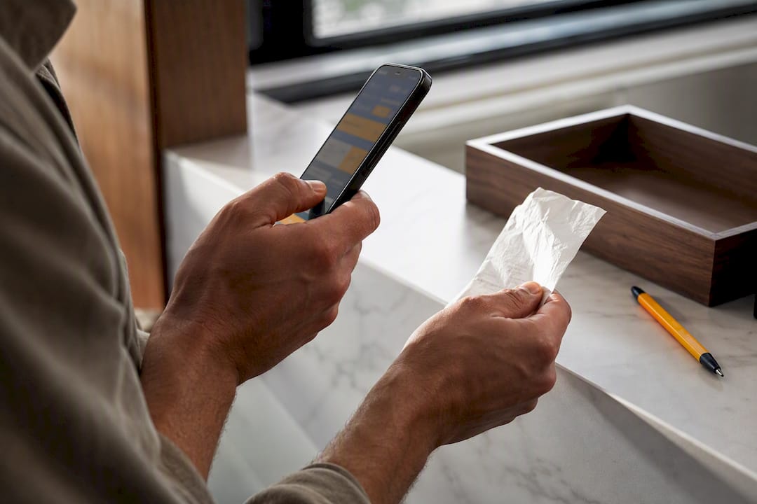 Hands testing a crumpled fuel receipt scan