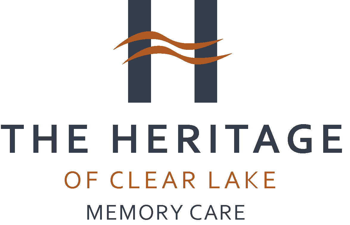 Logo of The Heritage of Clear Lake Memory Care with a stylized letter H and two brown wavy lines.