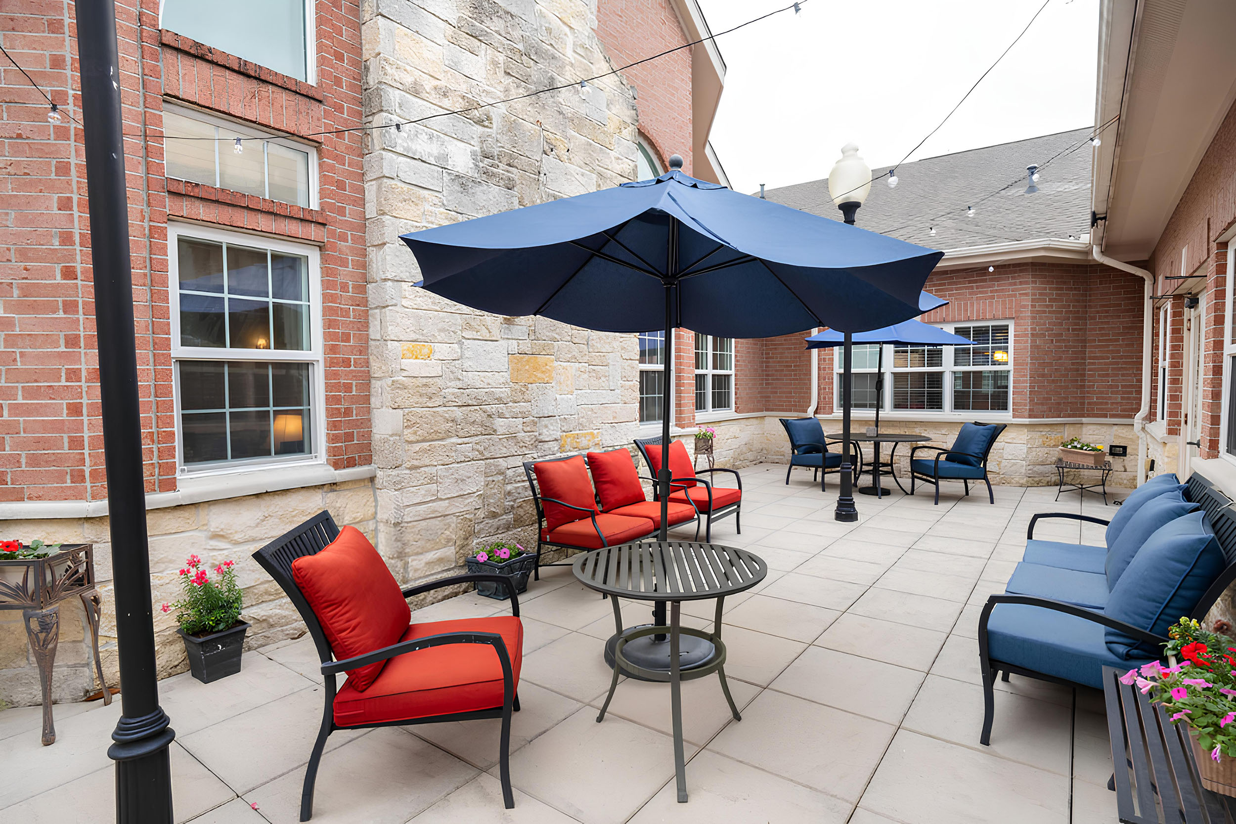 A cozy patio with shaded seating and vibrant cushions for relaxation