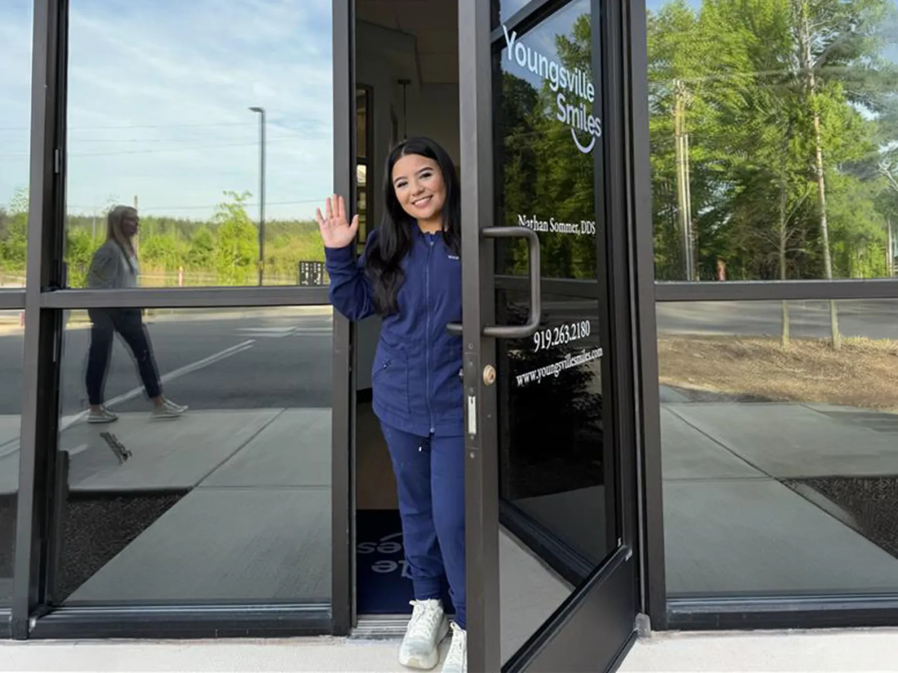 Team member in front of Youngsville Smiles