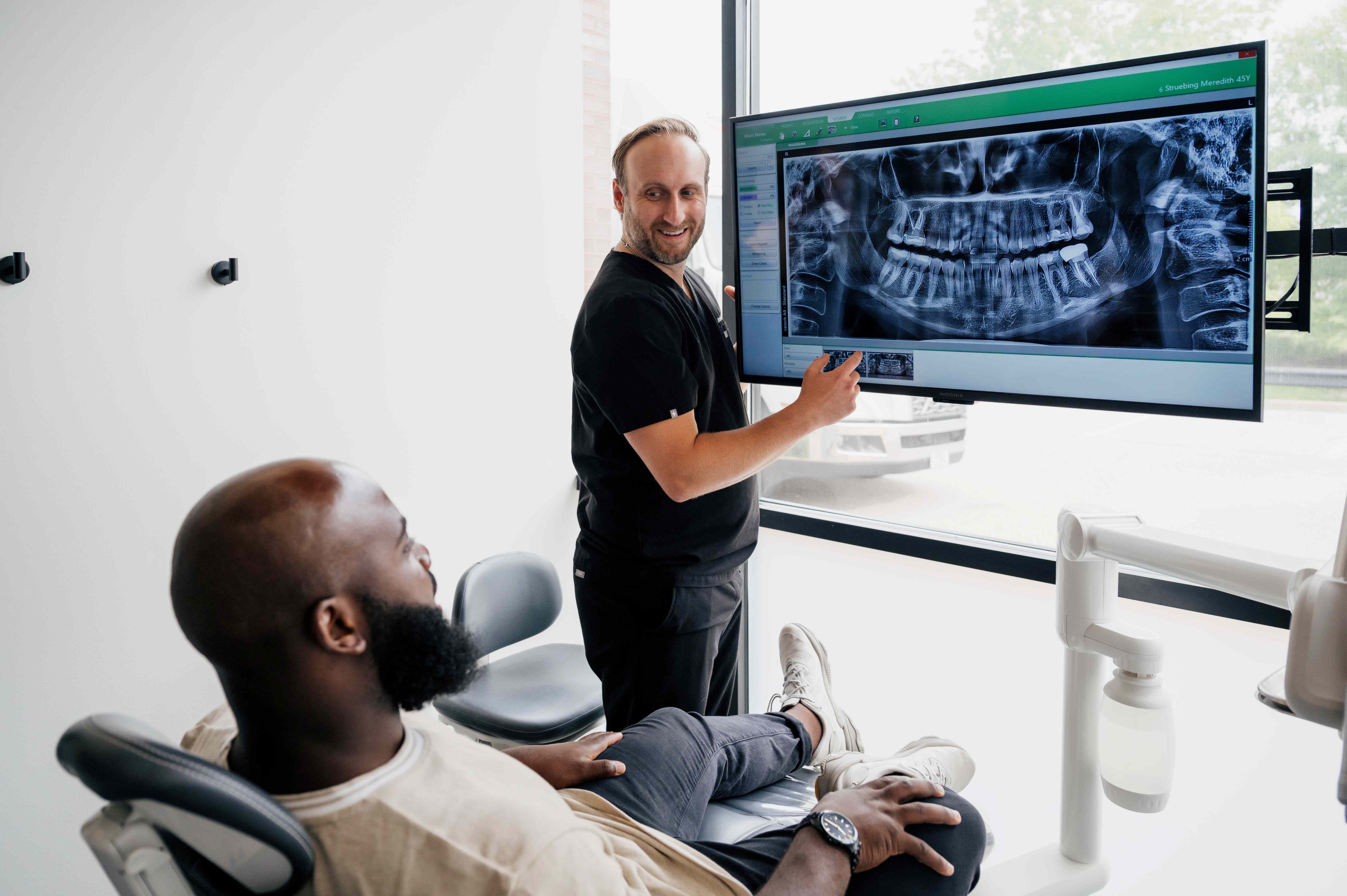 Our expert dentist at Monarch Valley Dental explaining the steps to a customized smile makeover to a patient