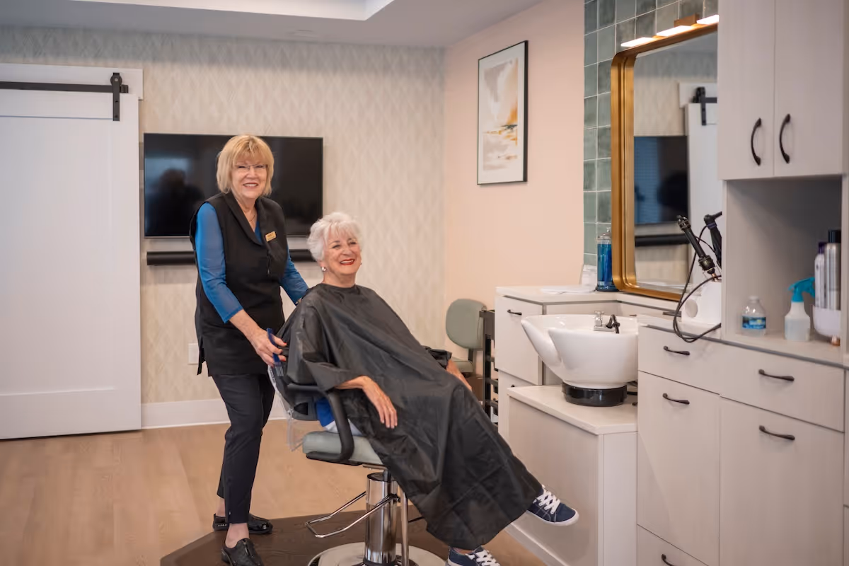 Senior woman enjoying a haircut in the on-site salon