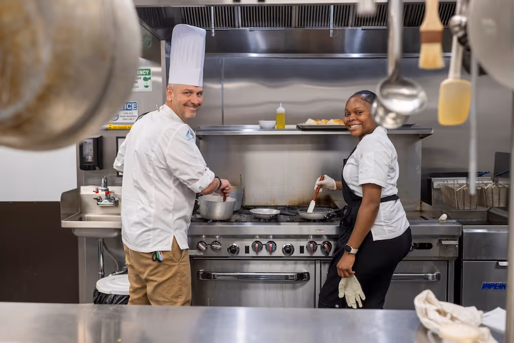 Chefs preparing meals in the professional kitchen at Elevate Clearwater