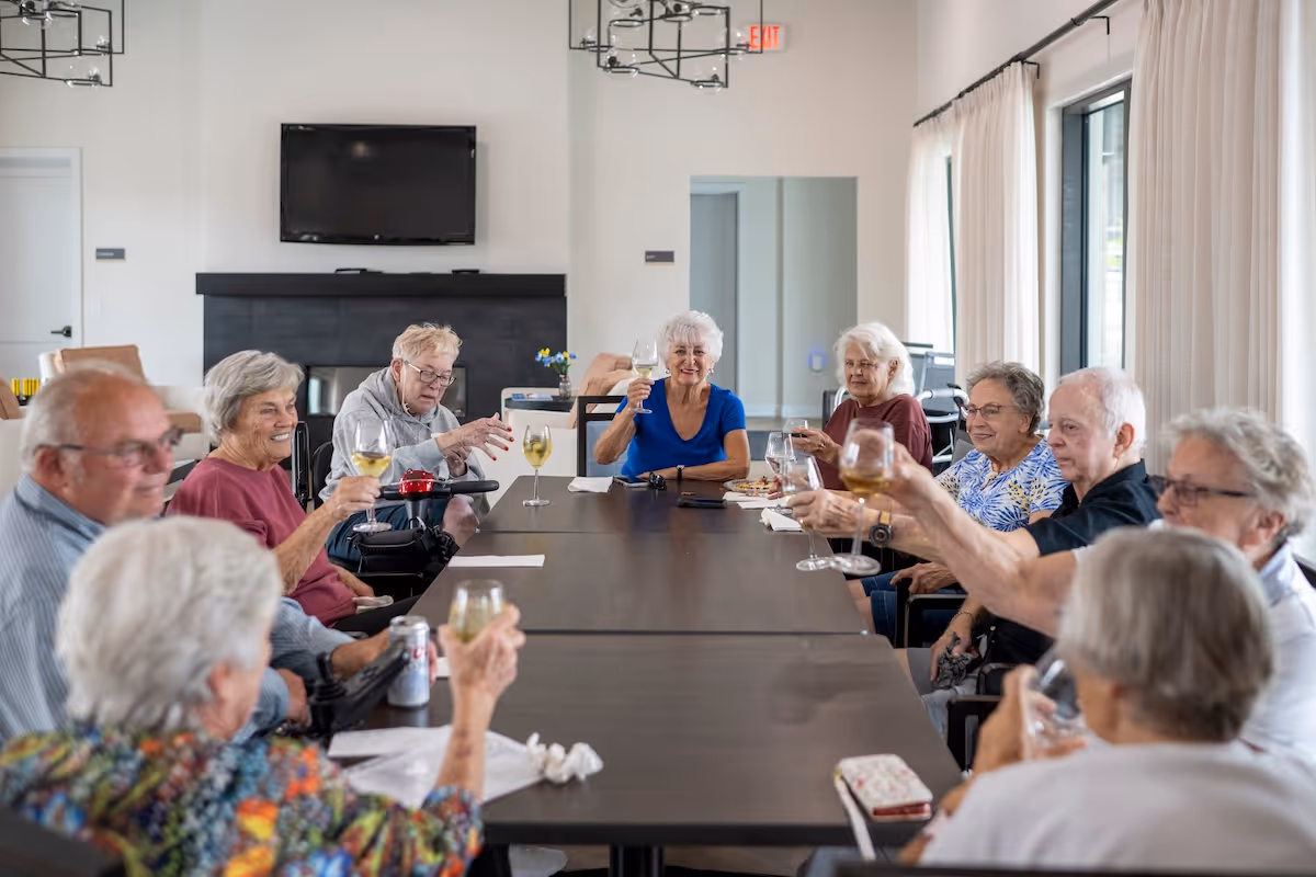 Group of senior residents enjoying a social gathering and toasting together