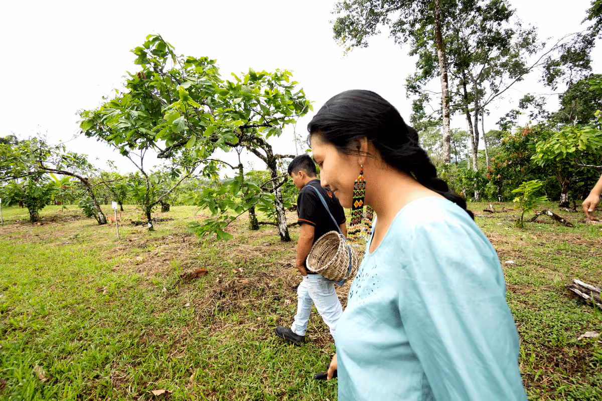 a woman in a blue dress walking through a field