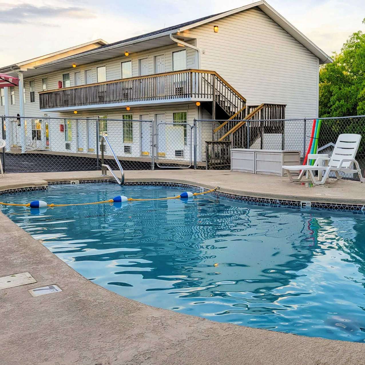 view of the sparkling outdoor pool, with the inn in the background.