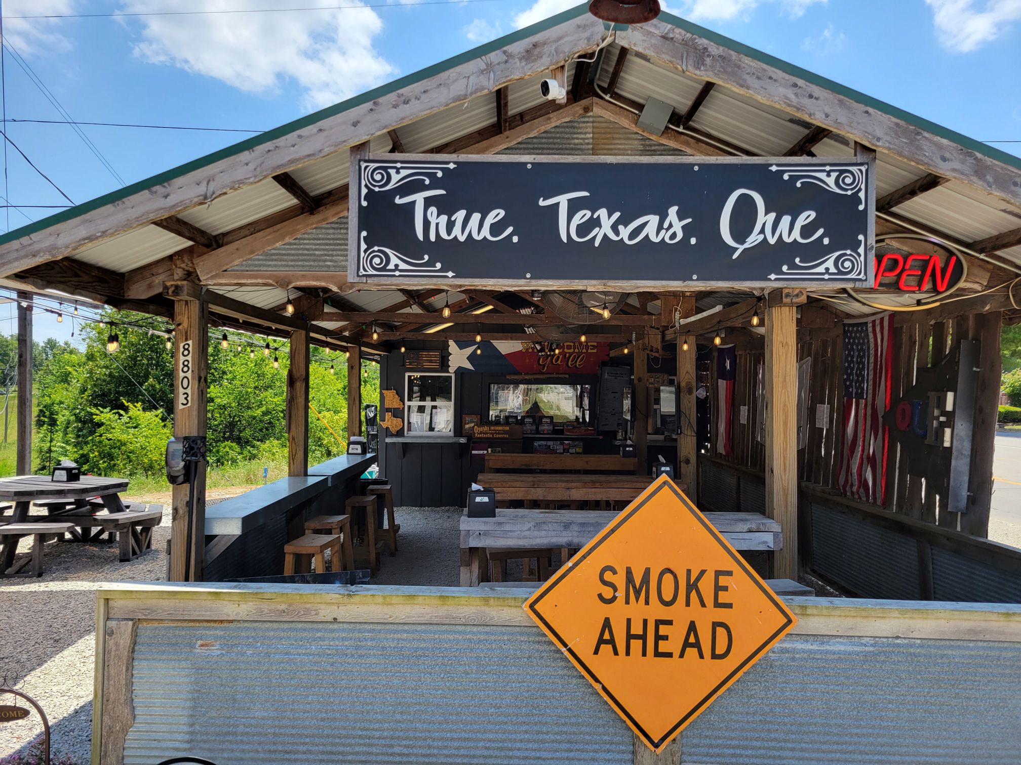 View of the CATI BBQ building. Sign says "True.
Texas. Que."
