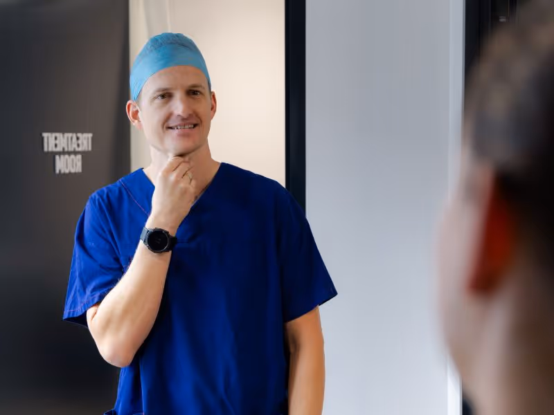 Dr Clifton talking to nurse in scrubs