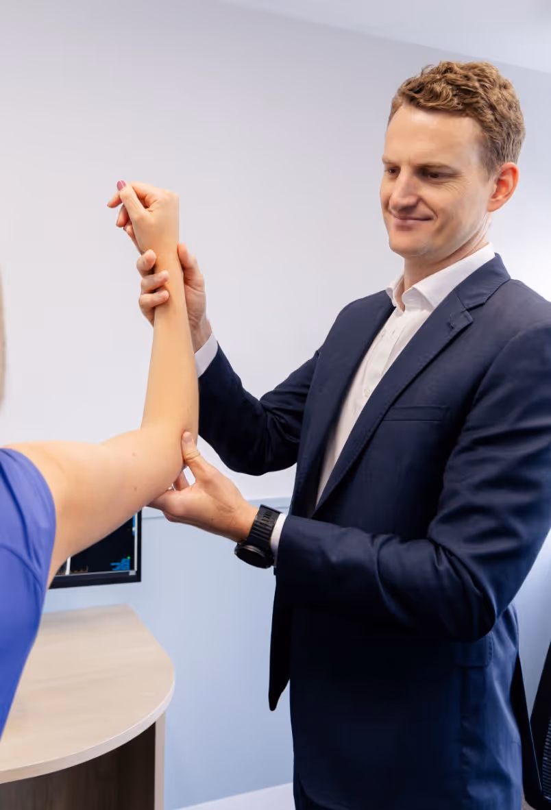 Dr Tom Clifton examining shoulder