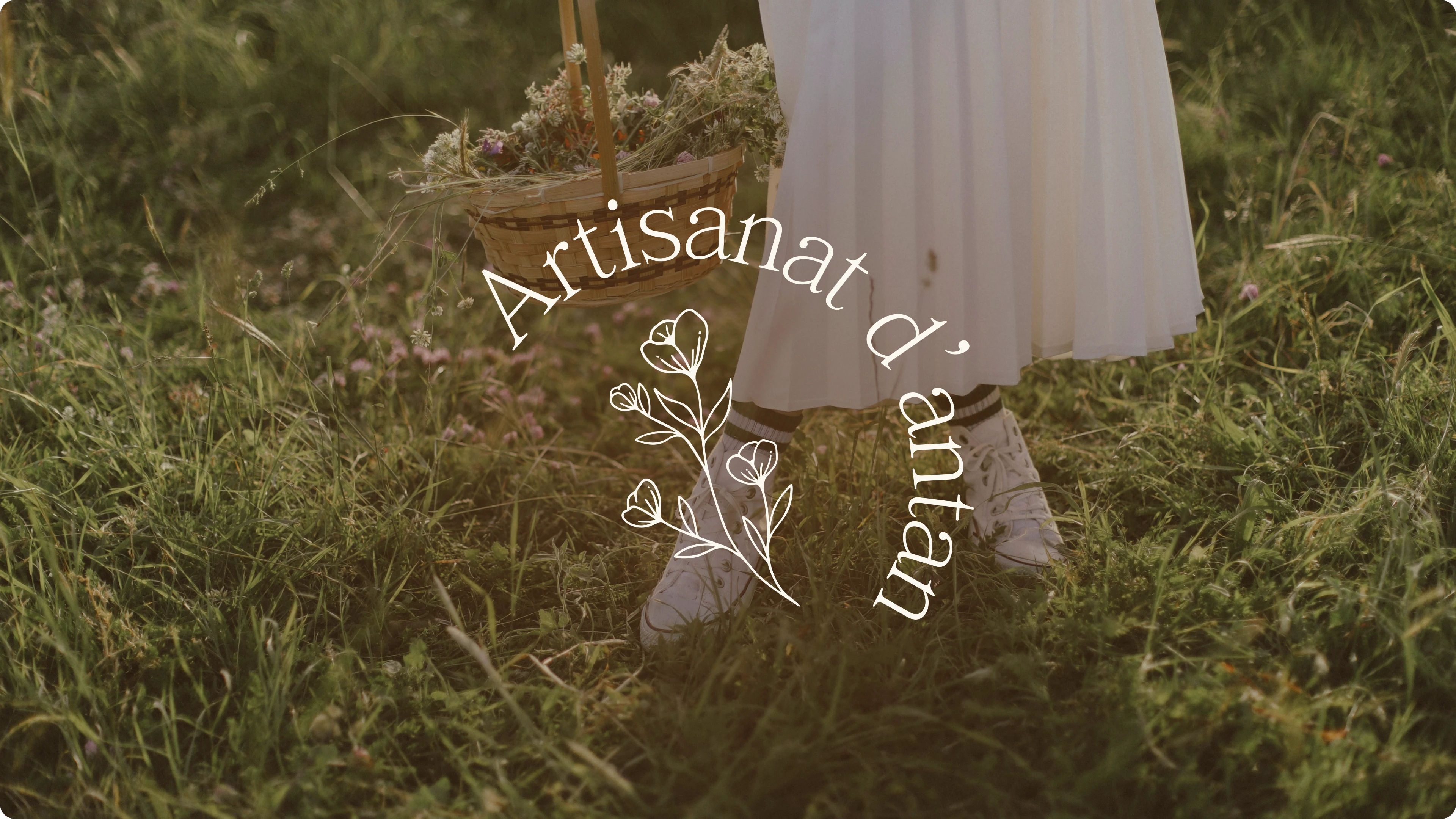 Logo Artisanat d'antan, sur un fond d'herbe avec une femme portant une robe blanche et un panier en osier