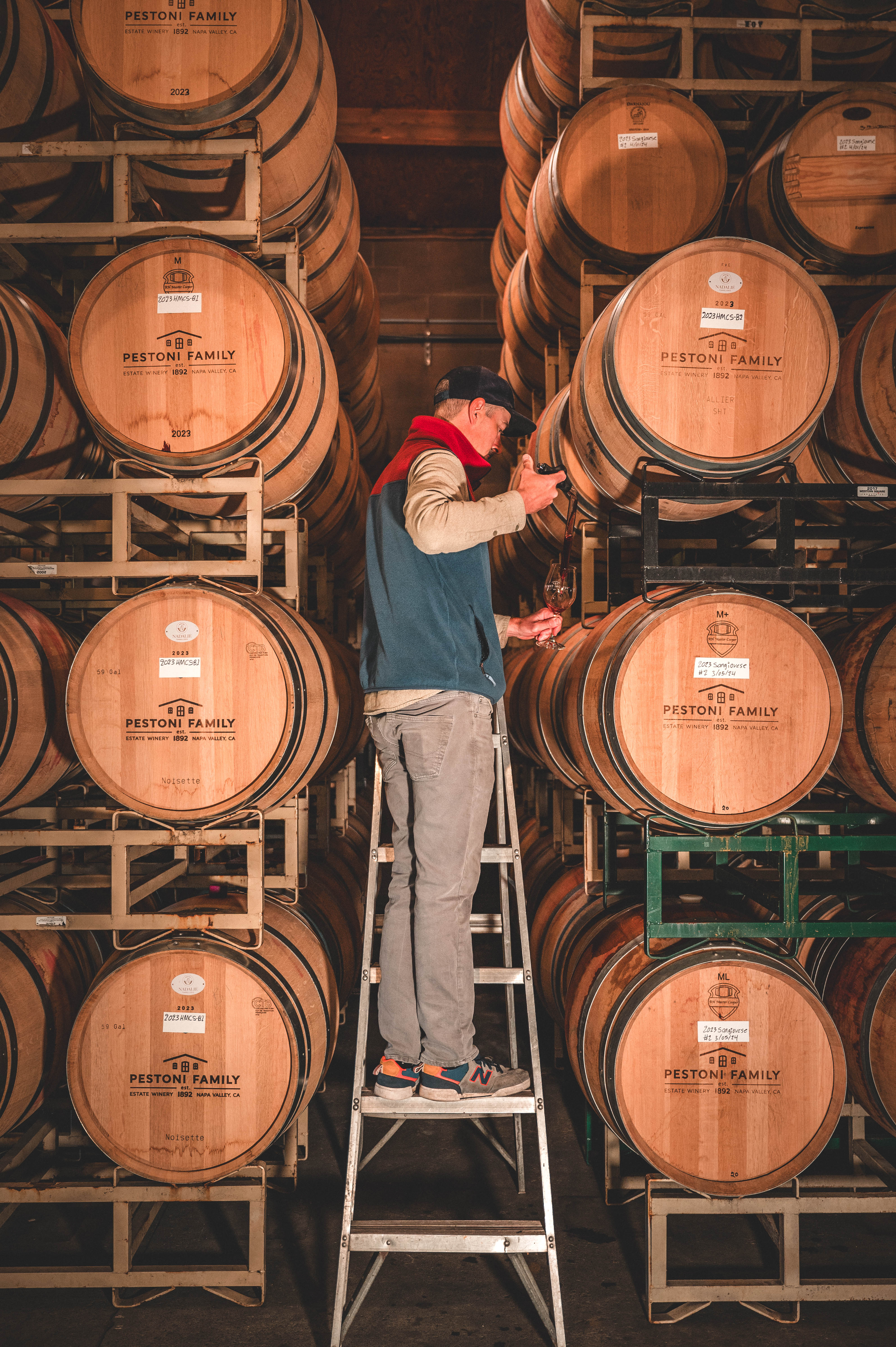 Pestoni Family Estate Vineyard assistant winemaker checking the wine barrel 