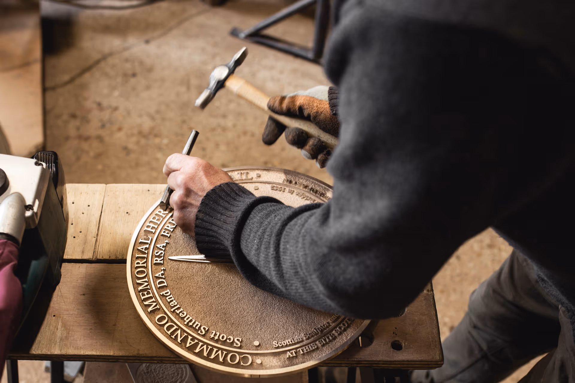 Hand-finishing bronze commemorative plaques, UK.