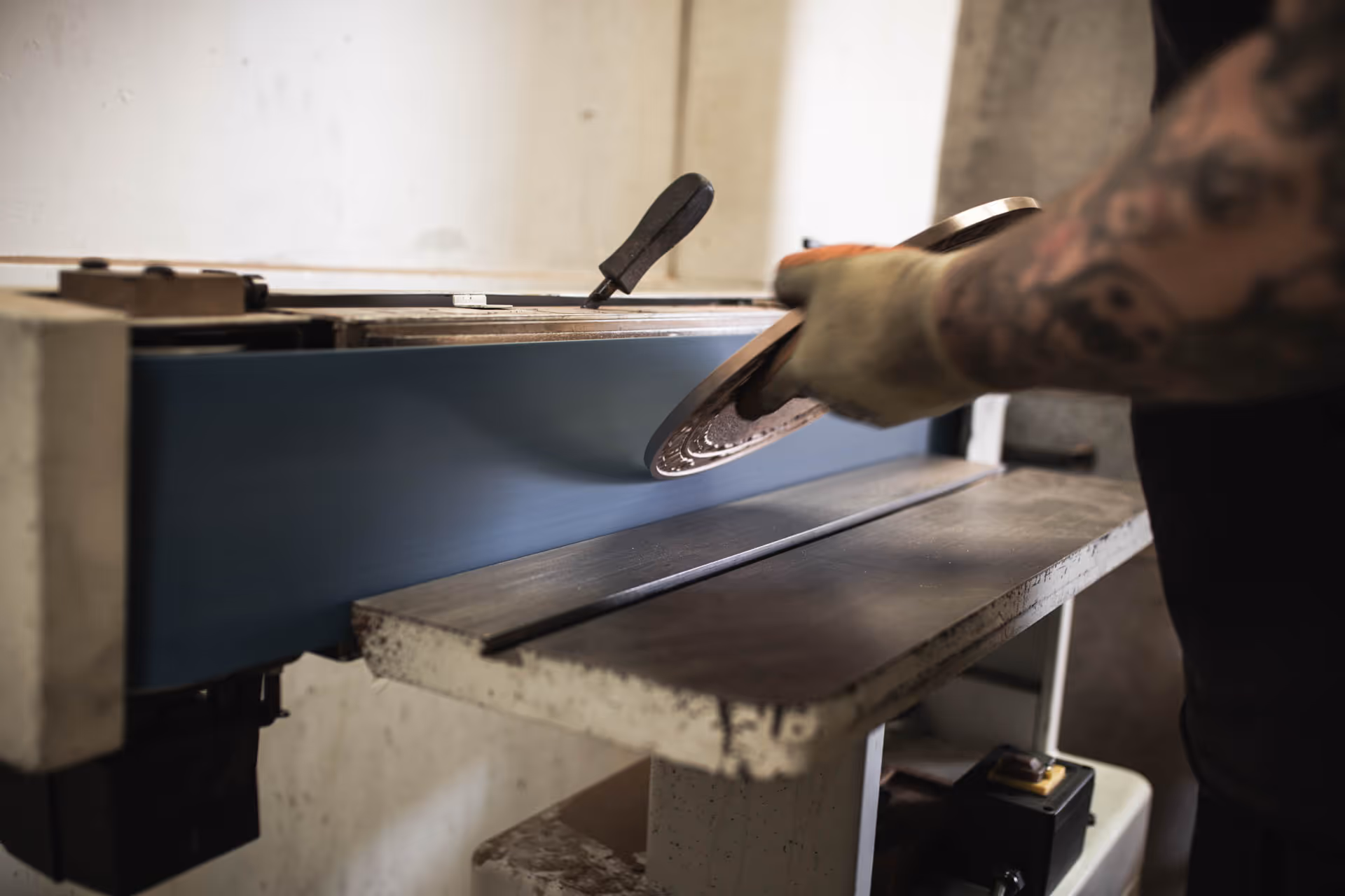 Hand-finishing bronze commemorative plaques, UK.