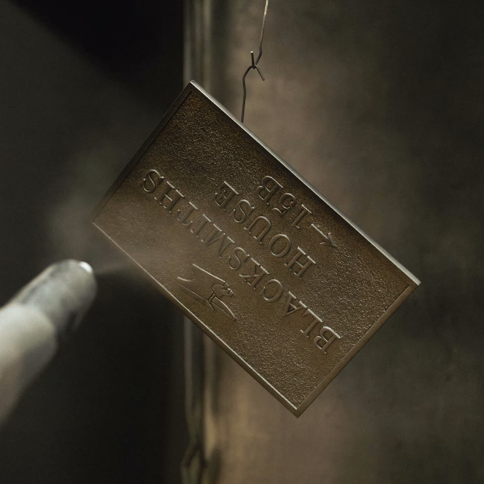 Powder coating aluminium house sign for Blacksmiths House during finishing process.