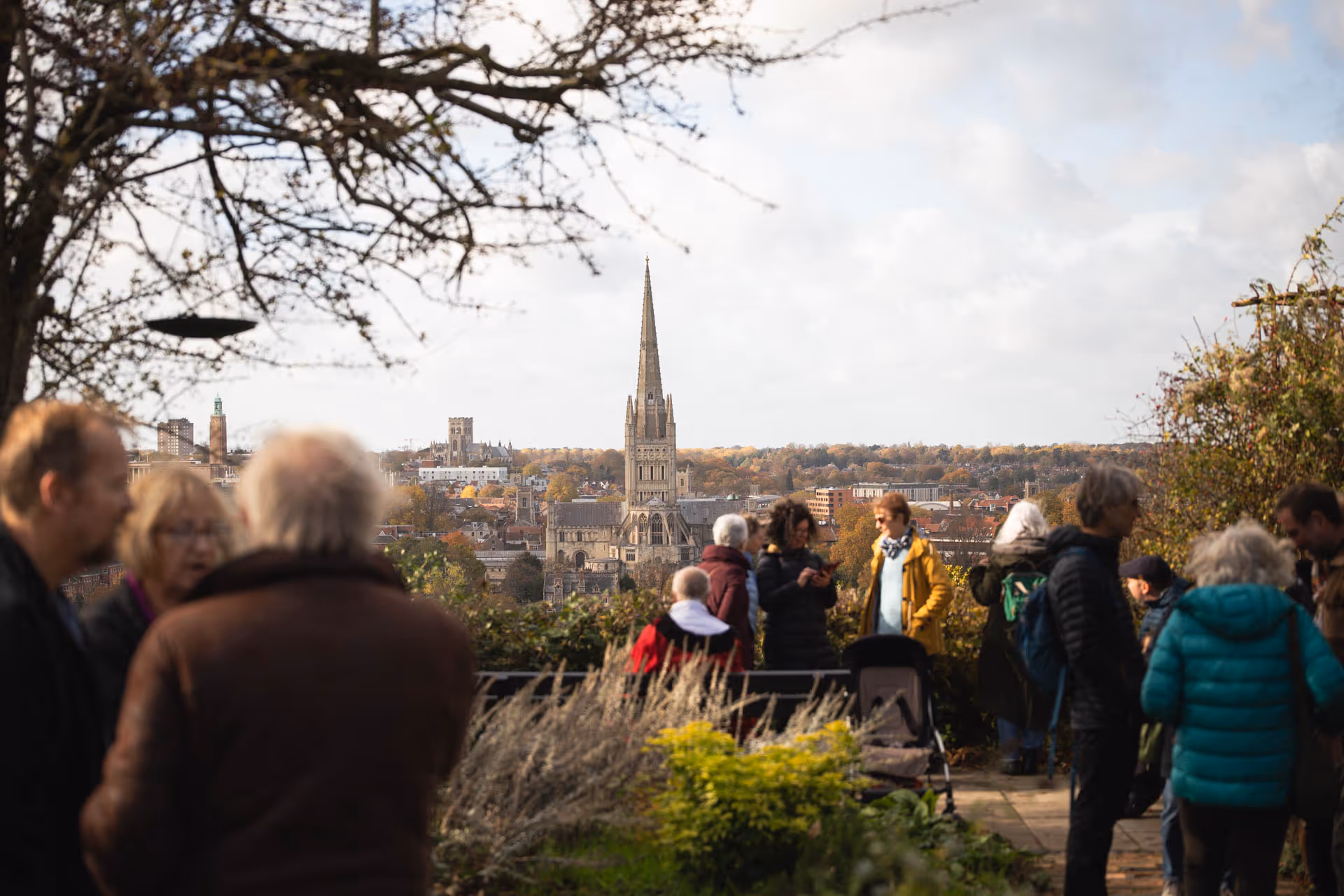 Attendees at Kett’s Heights enjoying the panoramic view of Norwich, with Norwich Cathedral and the city skyline in the background.