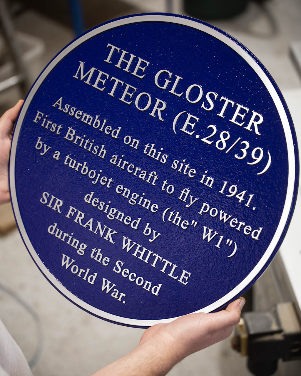 Custom metal blue plaque marking the site of the assembly of the Gloster Meteor aircraft, the UK's first operational jet fighter.