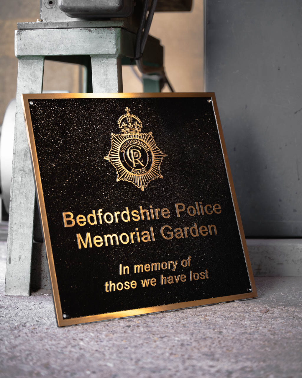 Large cast bronze memorial lawn tablet with a green painted background, commemorating the life of James Patrick Kennedy. Featuring gold lettering, decorative fleur-de-lis corner details, and an engraved Irish harp motif. A timeless Irish memorial plaque, crafted to honour a loved one with dignity and remembrance.
