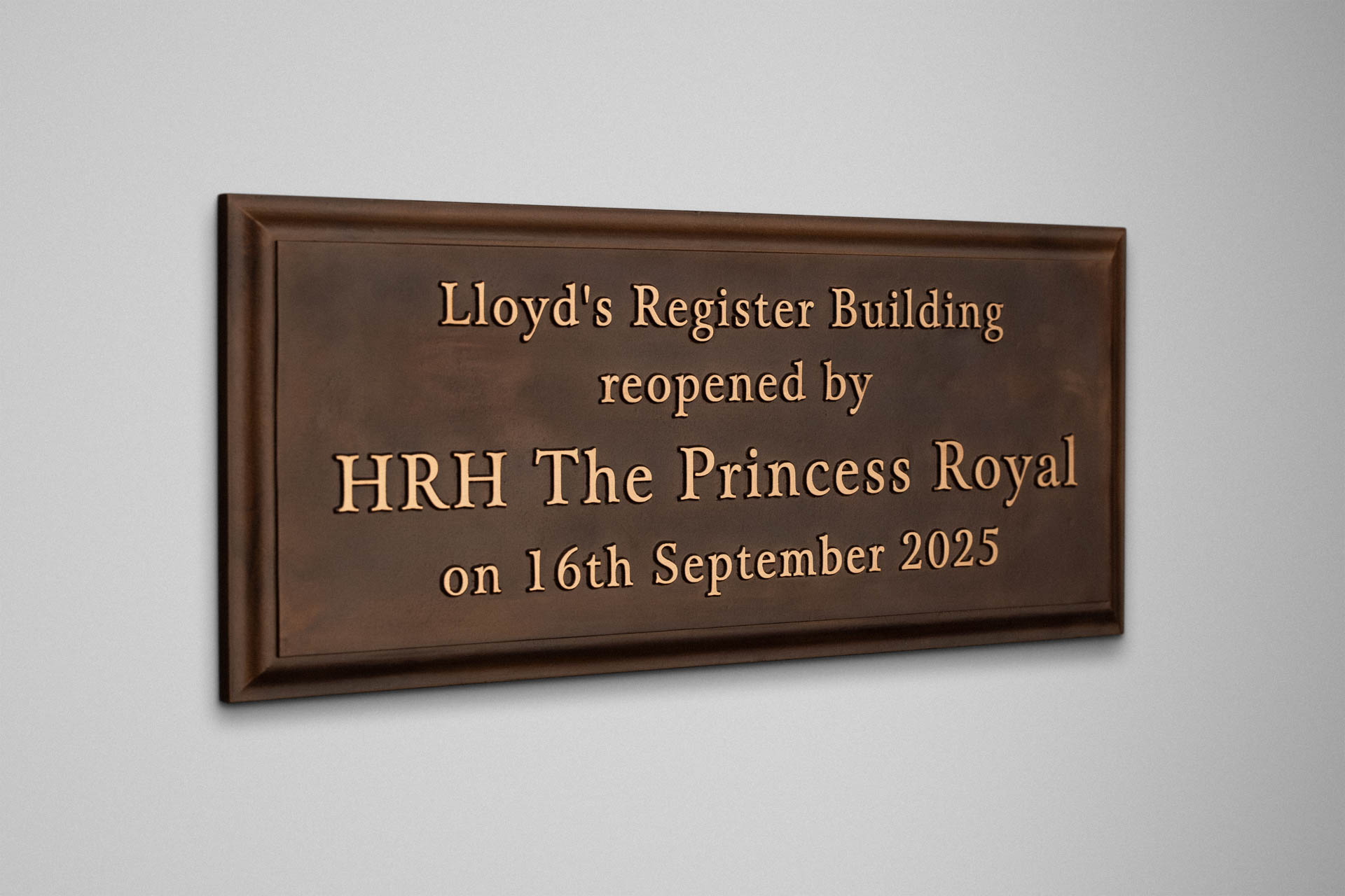Cast bronze commemorative plaque for Lloyd’s Register Building with polished raised lettering and bevelled border, patinated finish, inscribed to mark the reopening by HRH The Princess Royal on 16th September 2025.